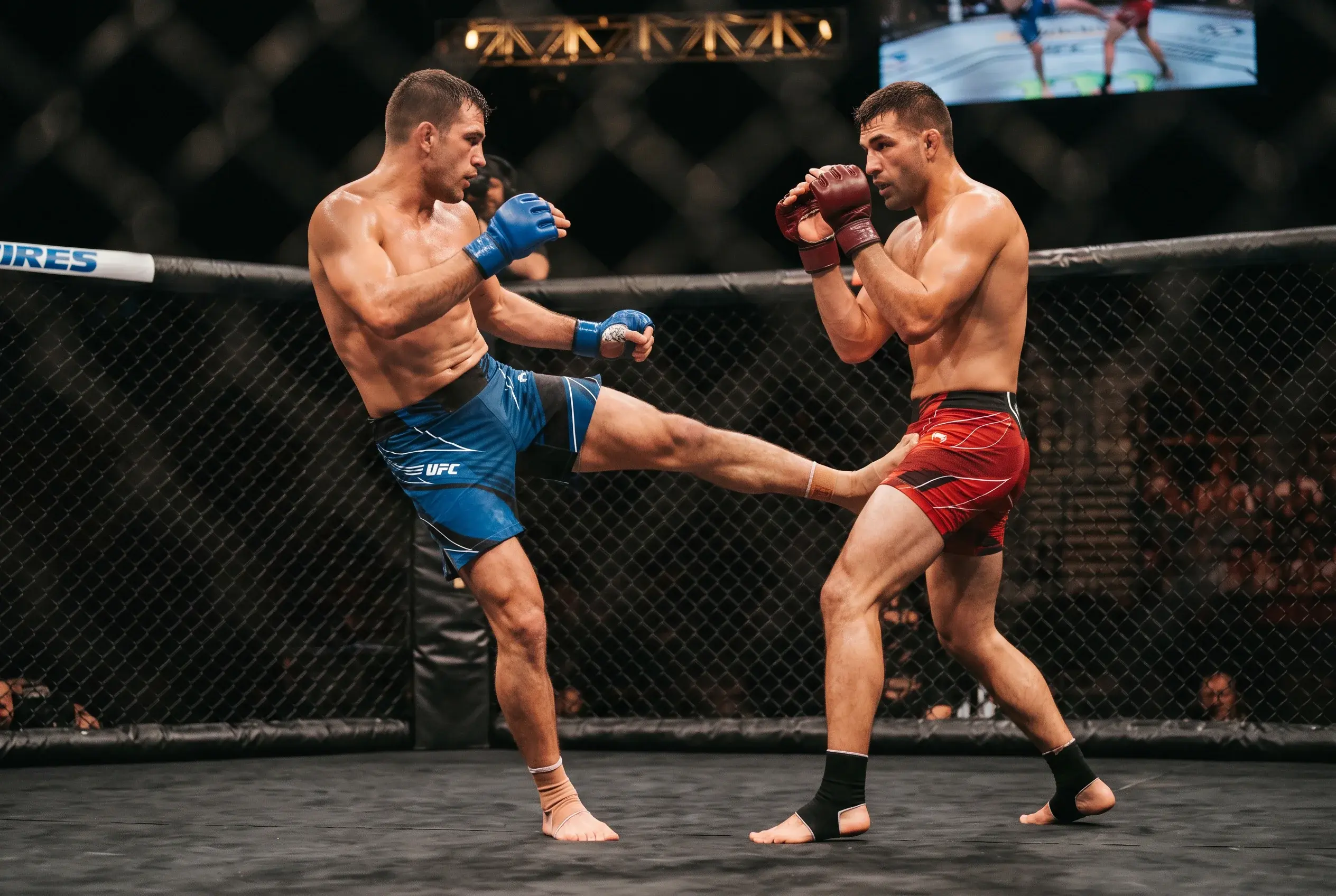 Two UFC fighters mid-strike exchange inside the octagon, one landing a leg kick on the lead leg of the other